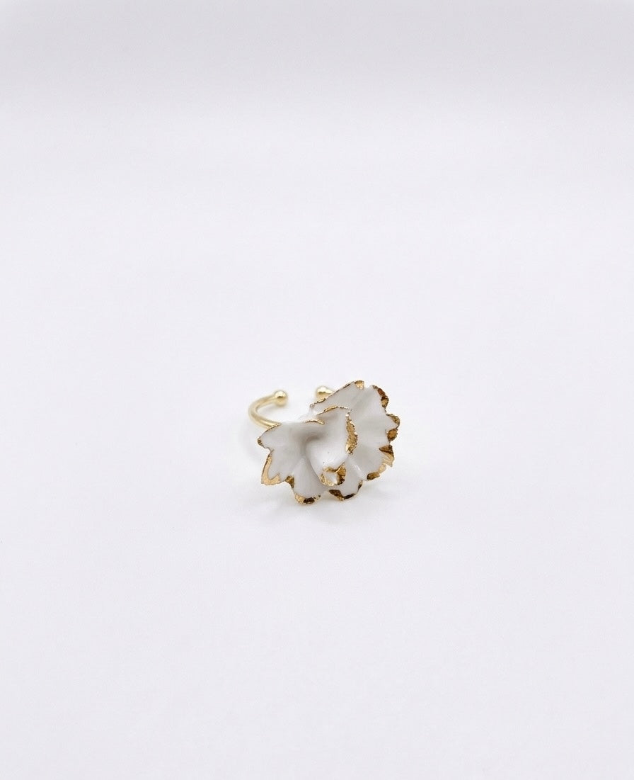 White floral ceramic ring with gold edges on a white background